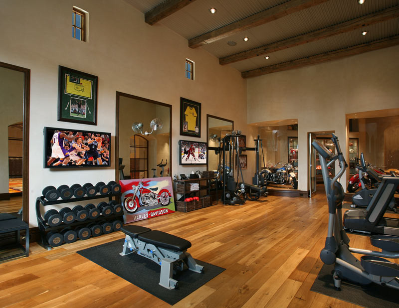 Design ideas for a large home weight room in Phoenix with beige walls and medium hardwood floors.