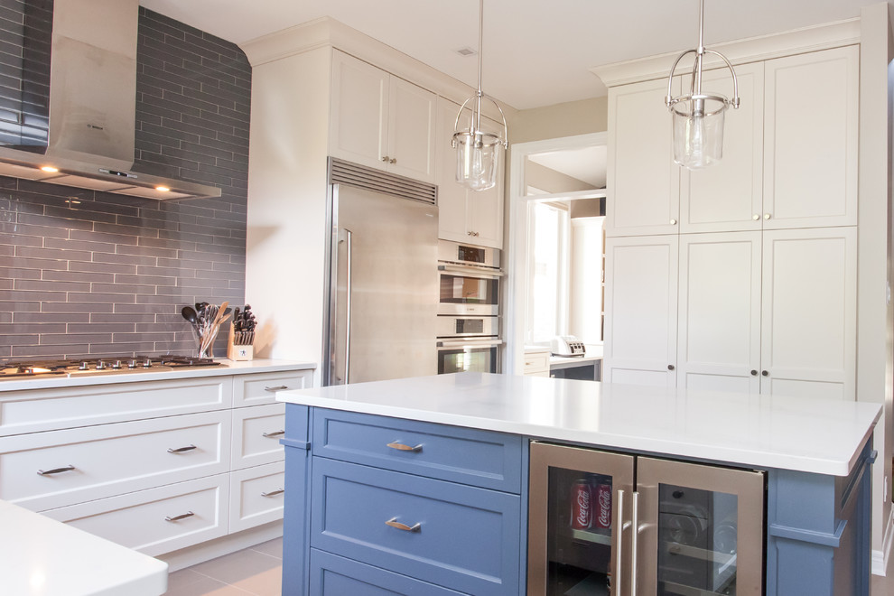 Inspiration for a large transitional u-shaped porcelain tile and gray floor eat-in kitchen remodel in Toronto with recessed-panel cabinets, white cabinets, quartz countertops, gray backsplash, subway tile backsplash, stainless steel appliances, an island, white countertops and an undermount sink