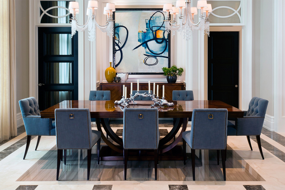 This is an example of a transitional dining room in Miami with marble floors.