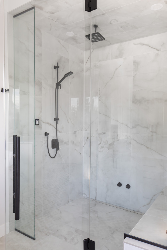 Example of a large transitional master white tile and porcelain tile porcelain tile, white floor and single-sink alcove shower design in Calgary with flat-panel cabinets, white cabinets, a two-piece toilet, white walls, an undermount sink, quartzite countertops, a hinged shower door, white countertops and a built-in vanity