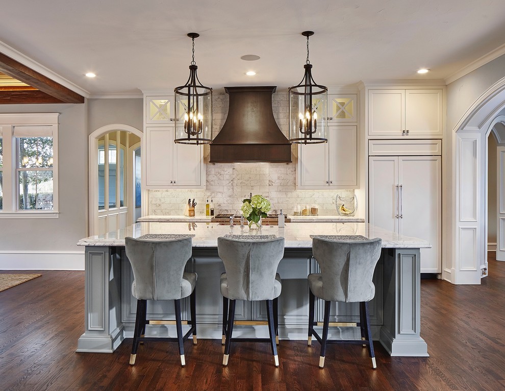 Inspiration for a traditional galley kitchen in Dallas with recessed-panel cabinets, white cabinets, beige splashback, panelled appliances, dark hardwood floors, with island, brown floor and white benchtop.