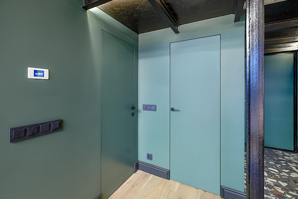 Photo of a mid-sized contemporary laundry room in Moscow with blue walls.