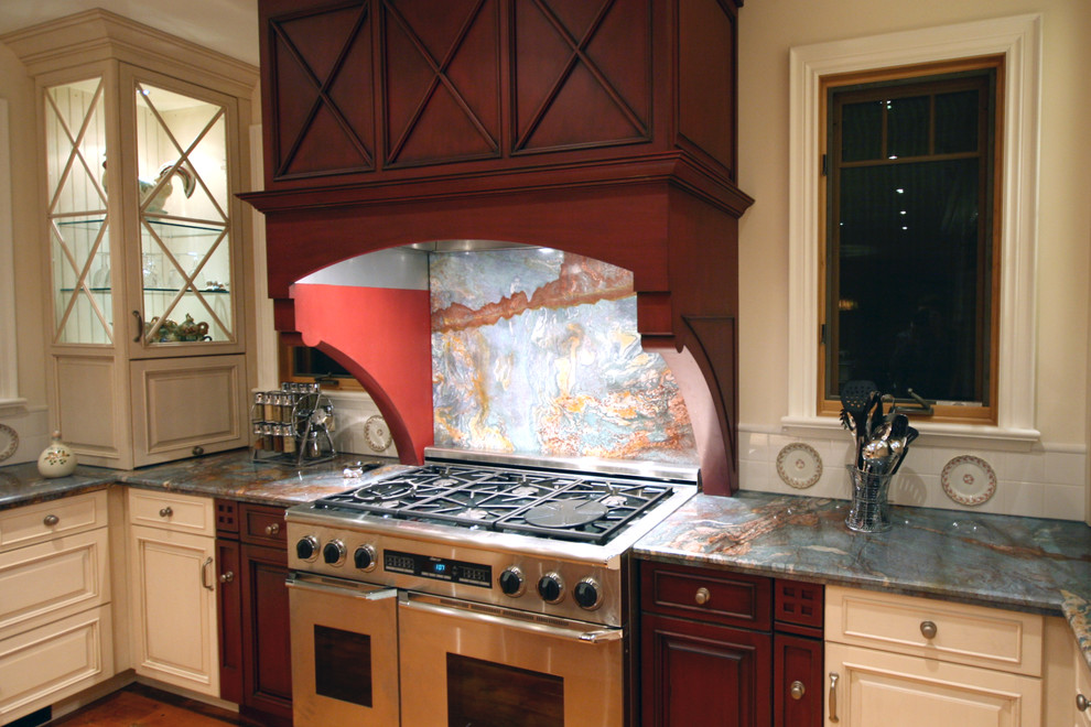 Example of a mid-sized transitional l-shaped enclosed kitchen design in Toronto with beige backsplash, stone slab backsplash, stainless steel appliances, an island, beaded inset cabinets and red cabinets
