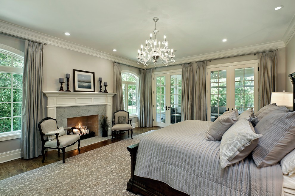Elegant master dark wood floor bedroom photo in Chicago with gray walls, a standard fireplace and a stone fireplace