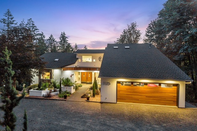 Example of a large minimalist white three-story wood house exterior design in Portland with a hip roof and a shingle roof
