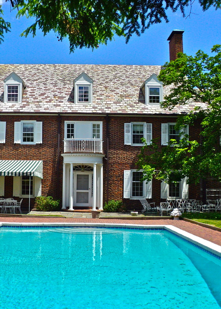 Inspiration for a traditional pool in New York with brick pavers.