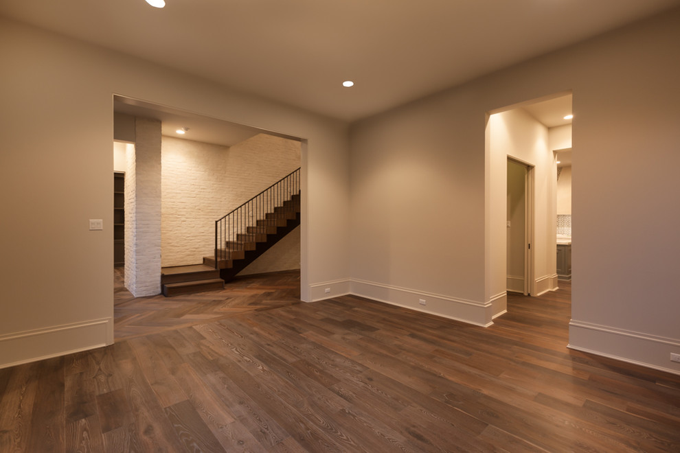 Example of a large transitional medium tone wood floor enclosed dining room design in Houston with beige walls