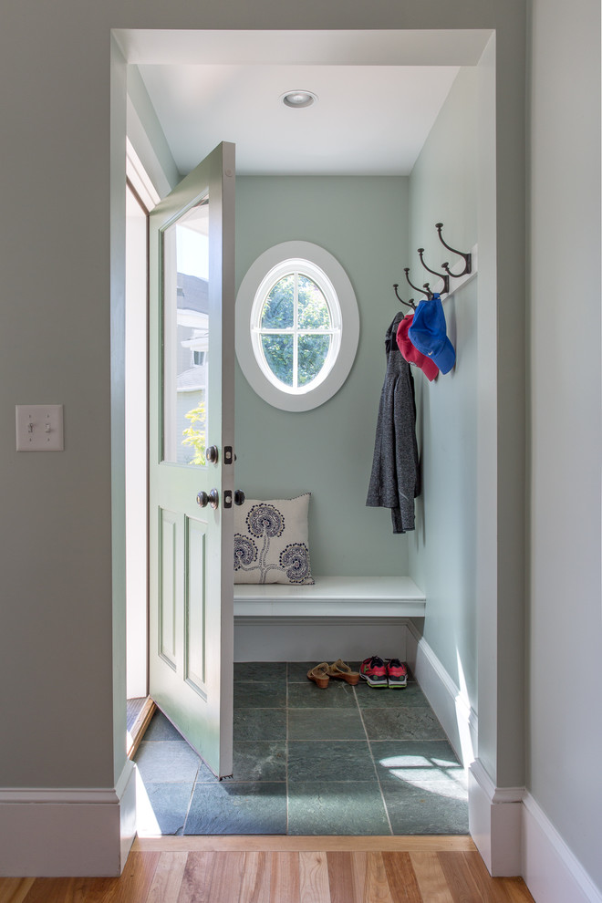 Photo of a small beach style foyer in Portland Maine with green walls, slate floors, a single front door and a green front door.