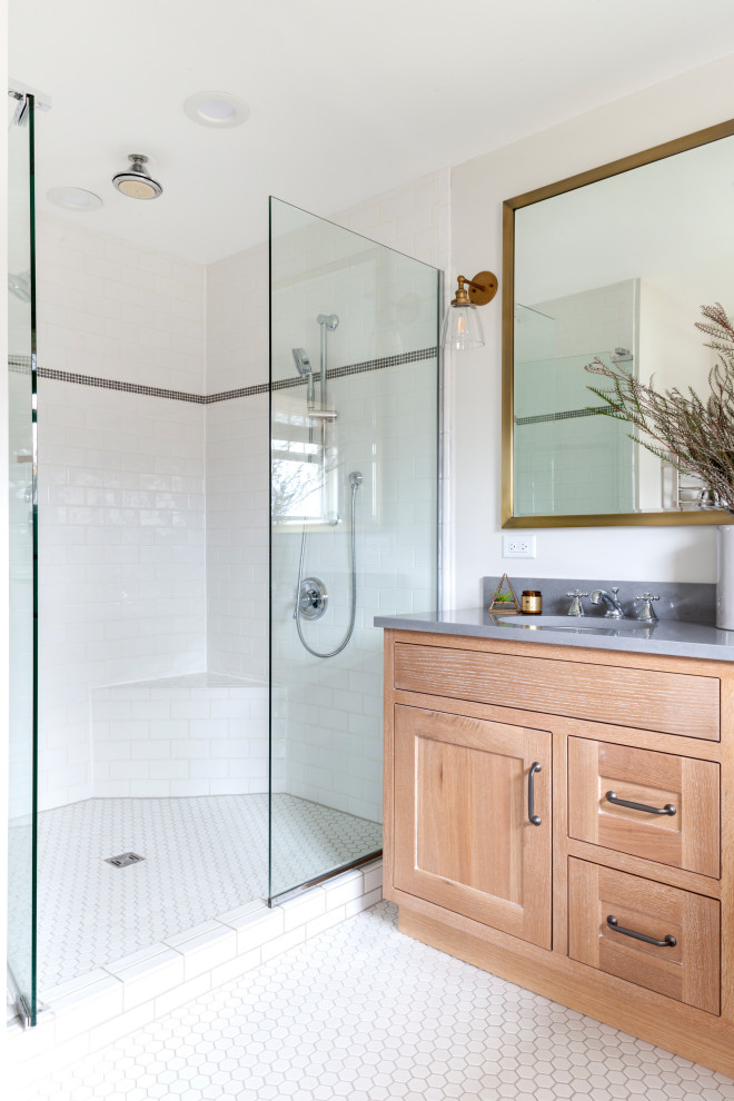 Alcove shower - mid-sized transitional master white tile ceramic tile, white floor and double-sink alcove shower idea in Chicago with shaker cabinets, light wood cabinets, a two-piece toilet, gray walls, a drop-in sink, quartz countertops, a hinged shower door, gray countertops and a freestanding vanity