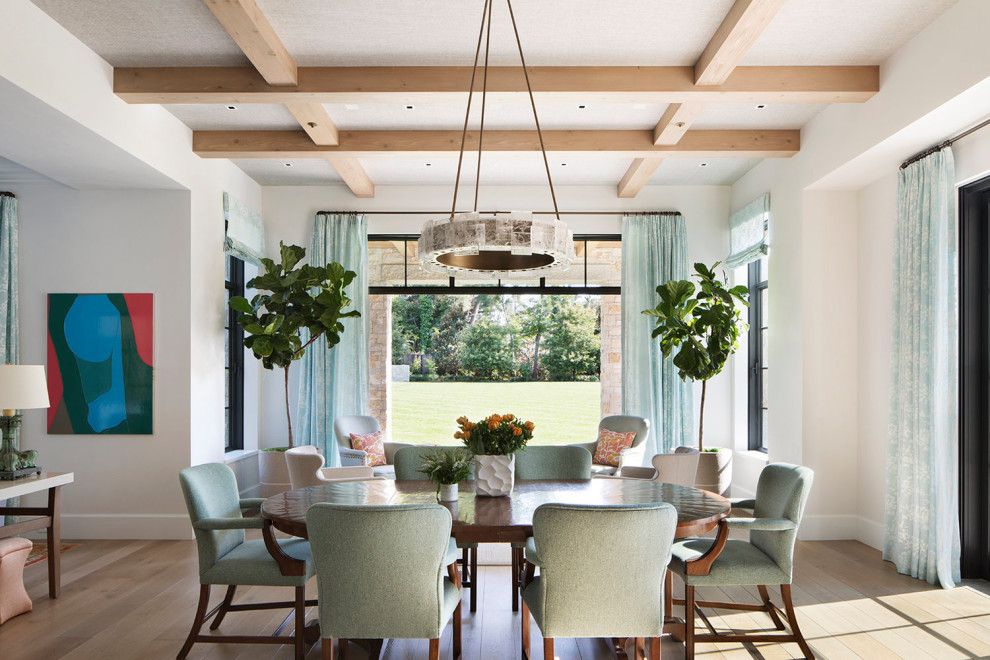This is an example of a transitional open plan dining in San Francisco with white walls, medium hardwood floors, no fireplace, brown floor and coffered.