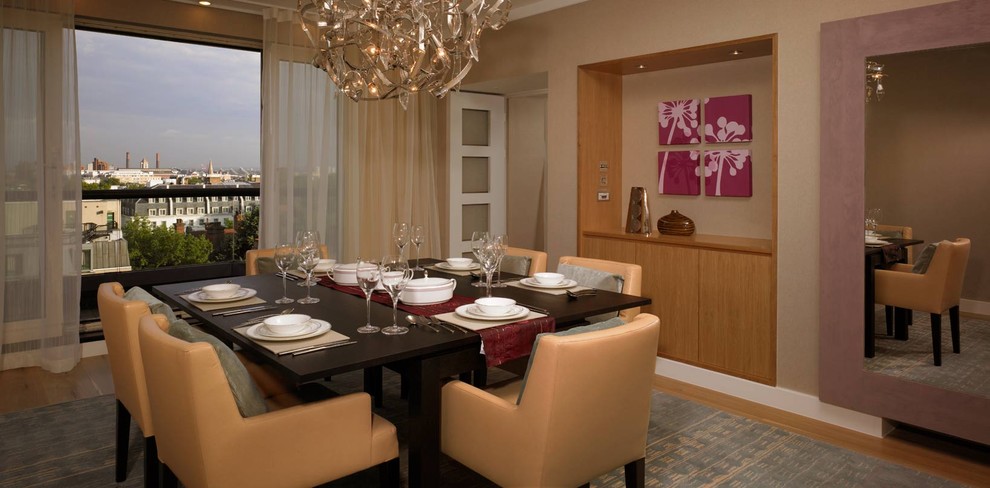 Photo of a contemporary dining room in London with beige walls and medium hardwood floors.