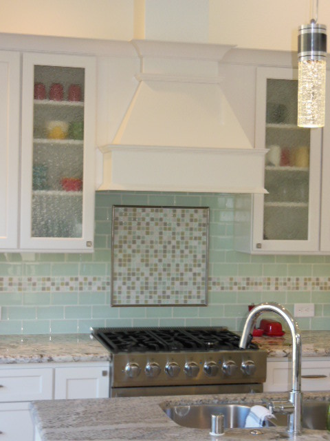 Inspiration for a mid-sized transitional l-shaped porcelain tile and white floor eat-in kitchen remodel in San Diego with an undermount sink, shaker cabinets, white cabinets, quartz countertops, green backsplash, subway tile backsplash, stainless steel appliances and an island