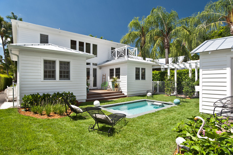 This is an example of a small beach style backyard rectangular pool in Miami.