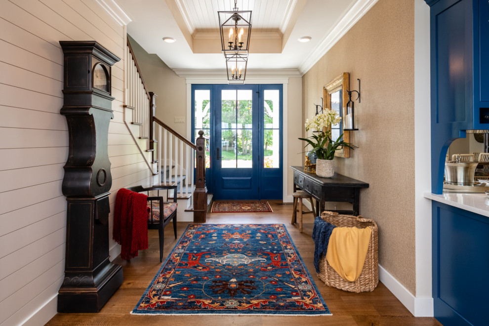 This is an example of a country foyer in Minneapolis with beige walls, medium hardwood floors, a single front door, a blue front door, brown floor, timber, planked wall panelling and wallpaper.