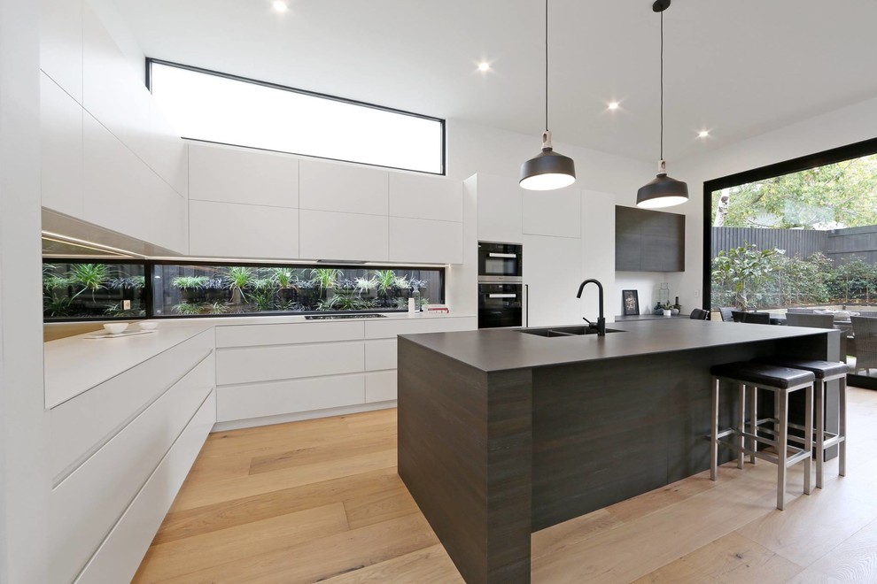 This is an example of a large contemporary kitchen in Melbourne.