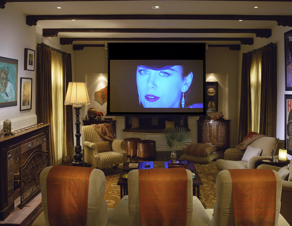 Photo of a mediterranean enclosed home theatre in Los Angeles with a projector screen.