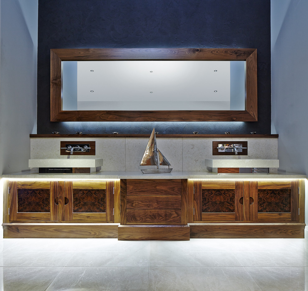 Contemporary bathroom in Other with a wall-mount sink and dark wood cabinets.