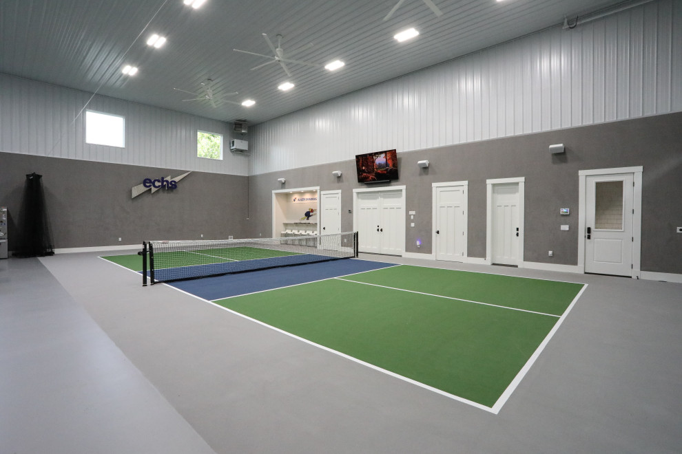 Expansive country indoor sport court in Other with grey walls and grey floor.