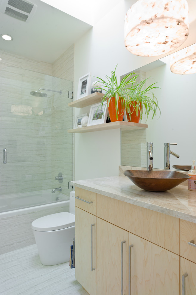 Small modern bathroom in Vancouver with flat-panel cabinets, light wood cabinets, an alcove tub, an alcove shower, a one-piece toilet, porcelain tile, white walls, porcelain floors, a vessel sink, white floor and a hinged shower door.