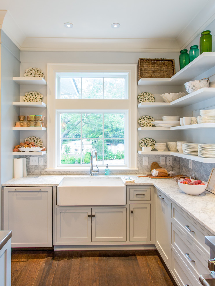 Country kitchen in Other with a farmhouse sink, shaker cabinets and white cabinets.