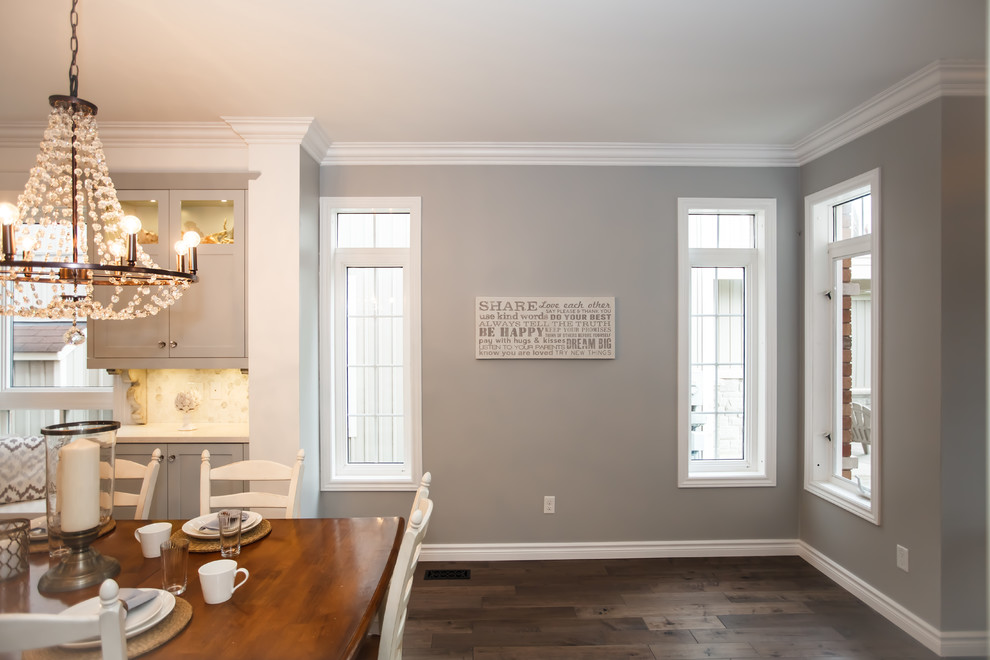 Example of a mid-sized transitional galley dark wood floor eat-in kitchen design in Toronto with an undermount sink, shaker cabinets, white cabinets, granite countertops, white backsplash, stone tile backsplash, stainless steel appliances and an island