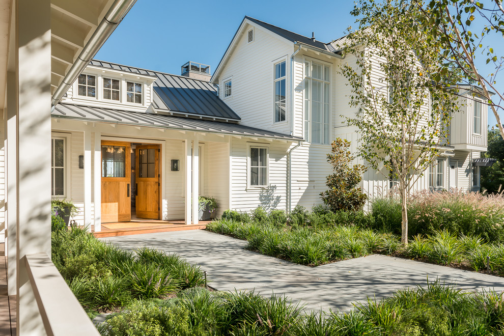 This is an example of a country two-storey white exterior in San Francisco with a gable roof.
