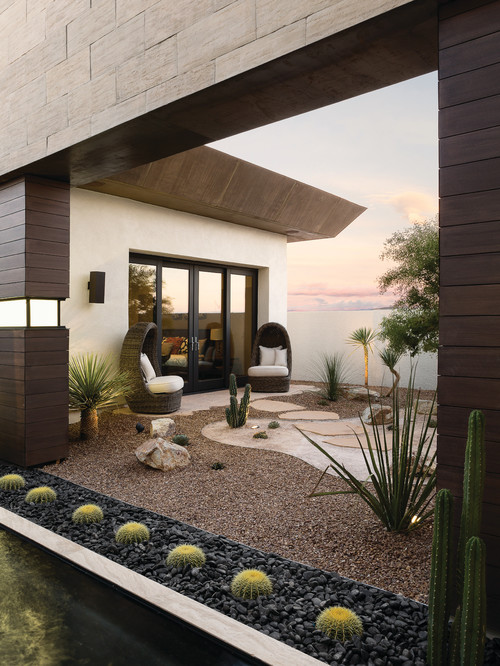 Cacti are perfect for lining areas, as they are easy to control and predict. These Cacti are in a stone bed lining this outdoor patio area, and are a perfect element for bringing a bit of vibrancy and life to a feature like this.