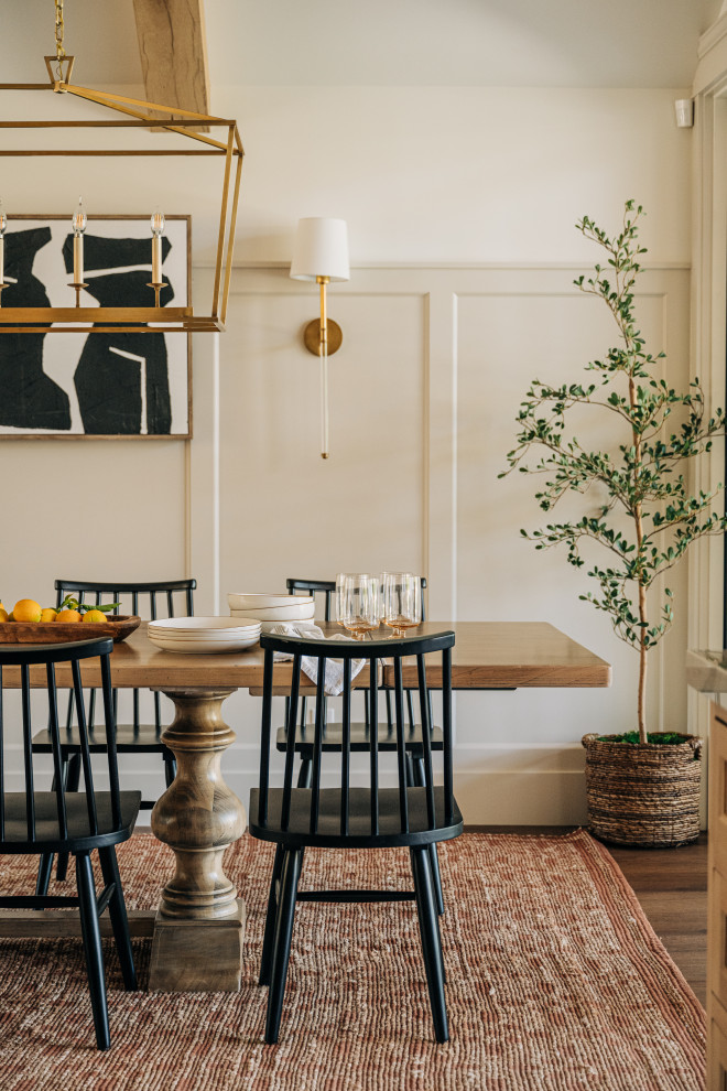 Transitional dark wood floor, brown floor and wainscoting dining room photo in Los Angeles with beige walls