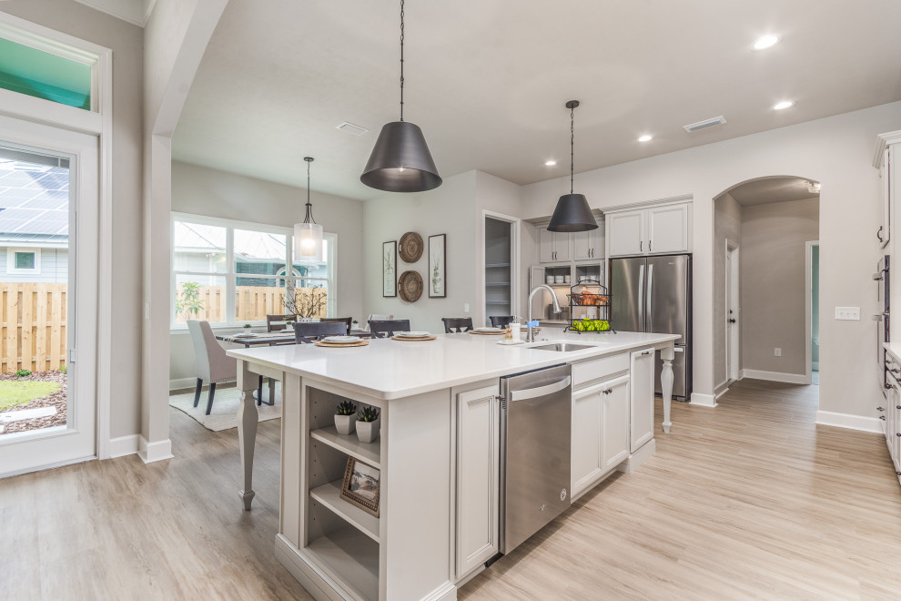 Inspiration for a mid-sized l-shaped eat-in kitchen in Other with a single-bowl sink, grey cabinets, quartzite benchtops, beige splashback, stone tile splashback, stainless steel appliances, vinyl floors, with island, brown floor and white benchtop.