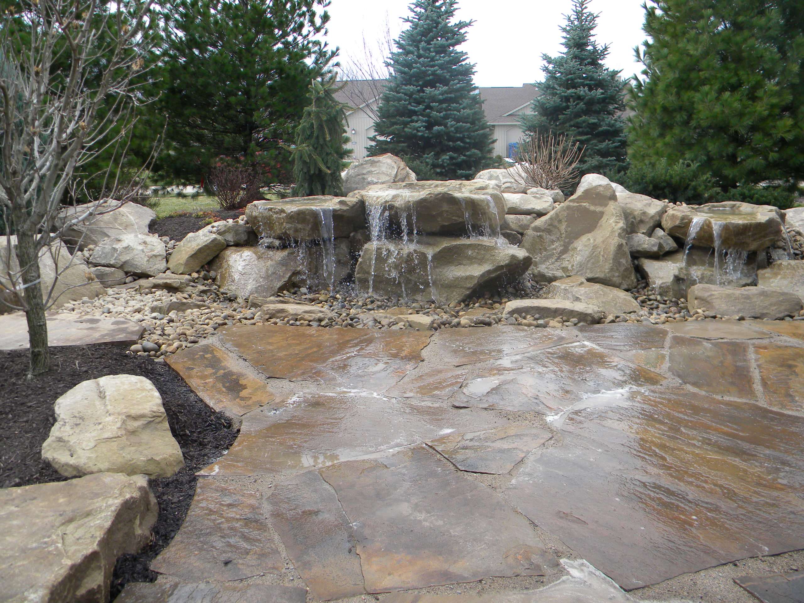 Carved stone water feature pondless and stone patio