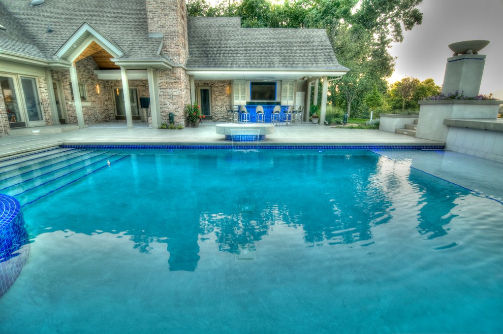 Inspiration for a large transitional backyard concrete paver and rectangular natural hot tub remodel in Cedar Rapids
