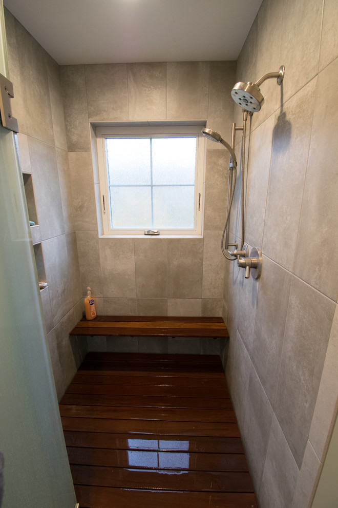 Mid-sized arts and crafts master wet room bathroom in Other with flat-panel cabinets, dark wood cabinets, beige tile, ceramic tile, grey walls, ceramic floors, a vessel sink, solid surface benchtops, beige floor and a hinged shower door.