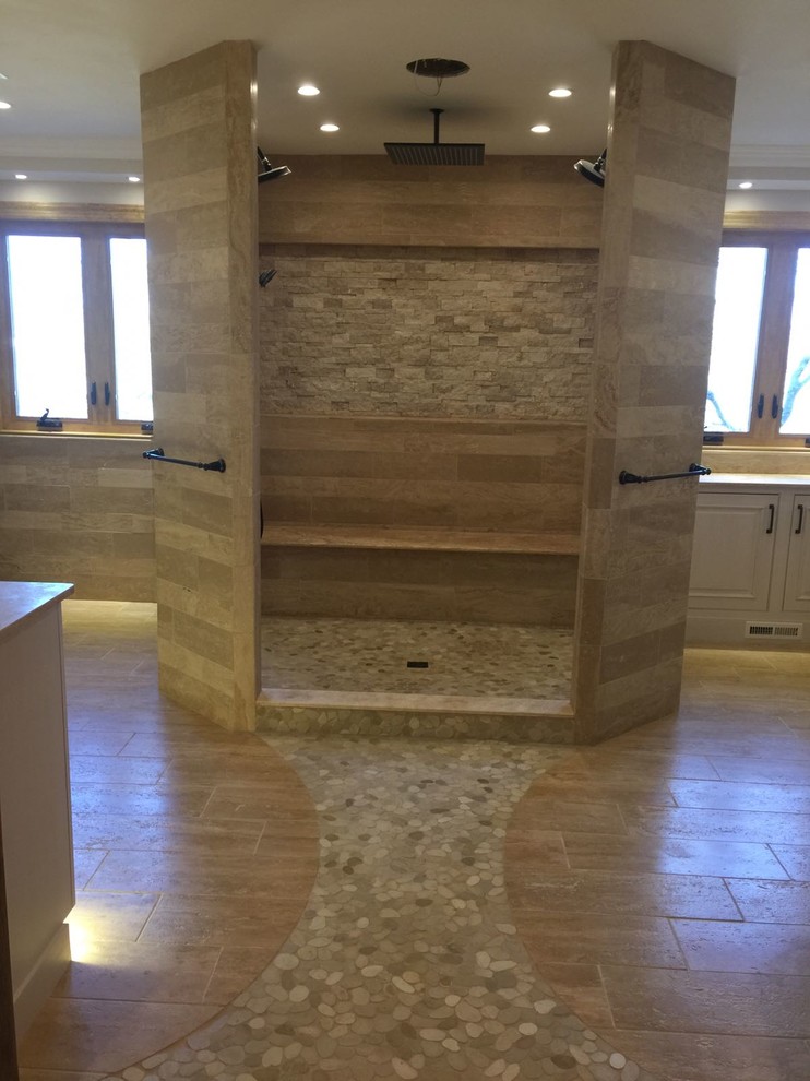 Large transitional master beige tile and stone tile travertine floor home design photo in Philadelphia with raised-panel cabinets, white cabinets, an undermount sink, limestone countertops, a one-piece toilet and beige walls