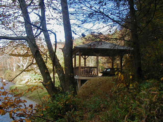 Inspiration for a mid-sized rustic backyard dock remodel in Raleigh with a pergola
