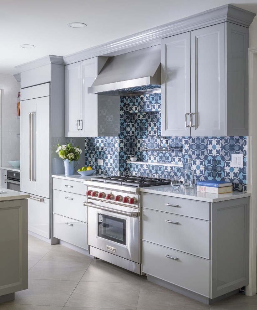 Photo of a large transitional galley kitchen in New York with an undermount sink, quartzite benchtops, blue splashback, panelled appliances, porcelain floors, grey floor, white benchtop, recessed-panel cabinets, grey cabinets and cement tile splashback.