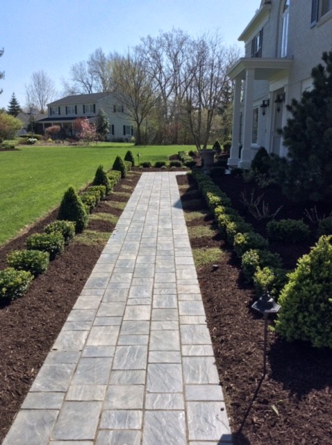 Photo of a large traditional garden in Cleveland with concrete pavers.