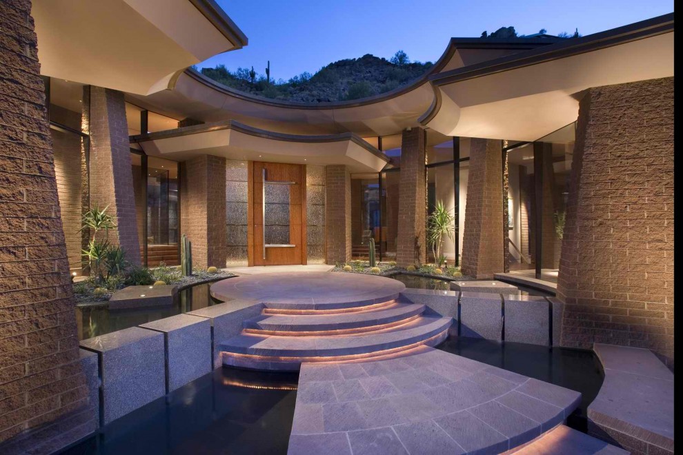 This is an example of a contemporary entryway in Phoenix with a single front door and a glass front door.
