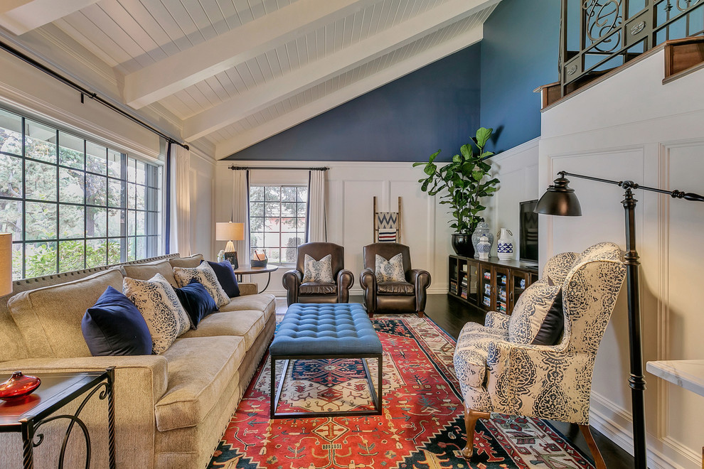This is an example of a large traditional formal open concept living room in Los Angeles with blue walls, medium hardwood floors, no fireplace and a freestanding tv.