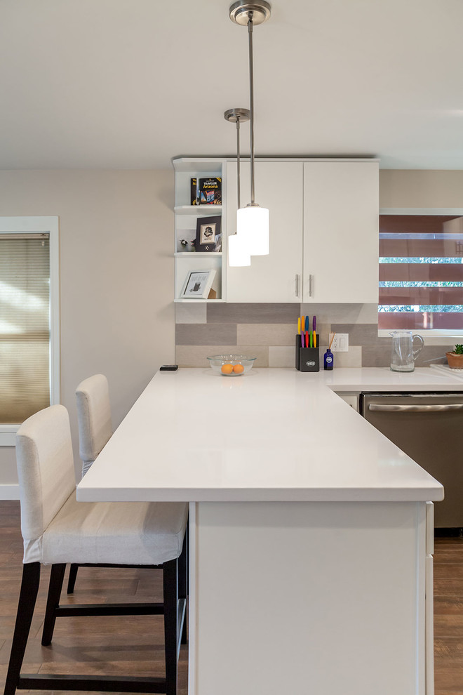 Transitional u-shaped porcelain tile open concept kitchen photo in Phoenix with a farmhouse sink, shaker cabinets, white cabinets, quartz countertops, multicolored backsplash, porcelain backsplash, stainless steel appliances and an island