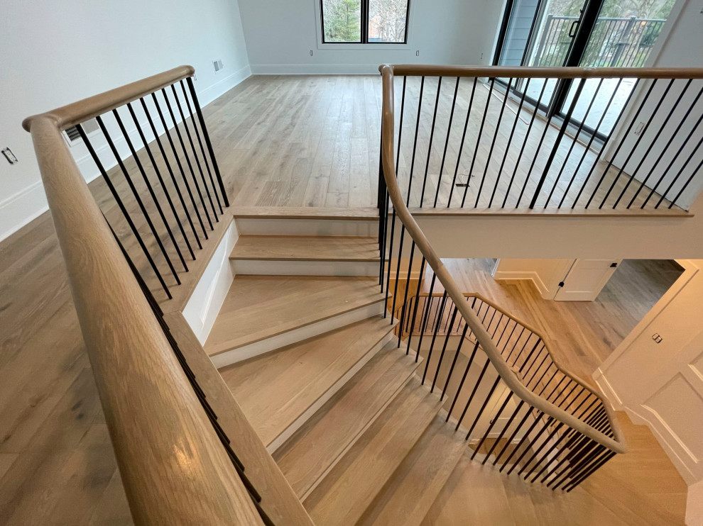 Inspiration for a large transitional wood floating staircase in DC Metro with painted wood risers, mixed railing and decorative wall panelling.