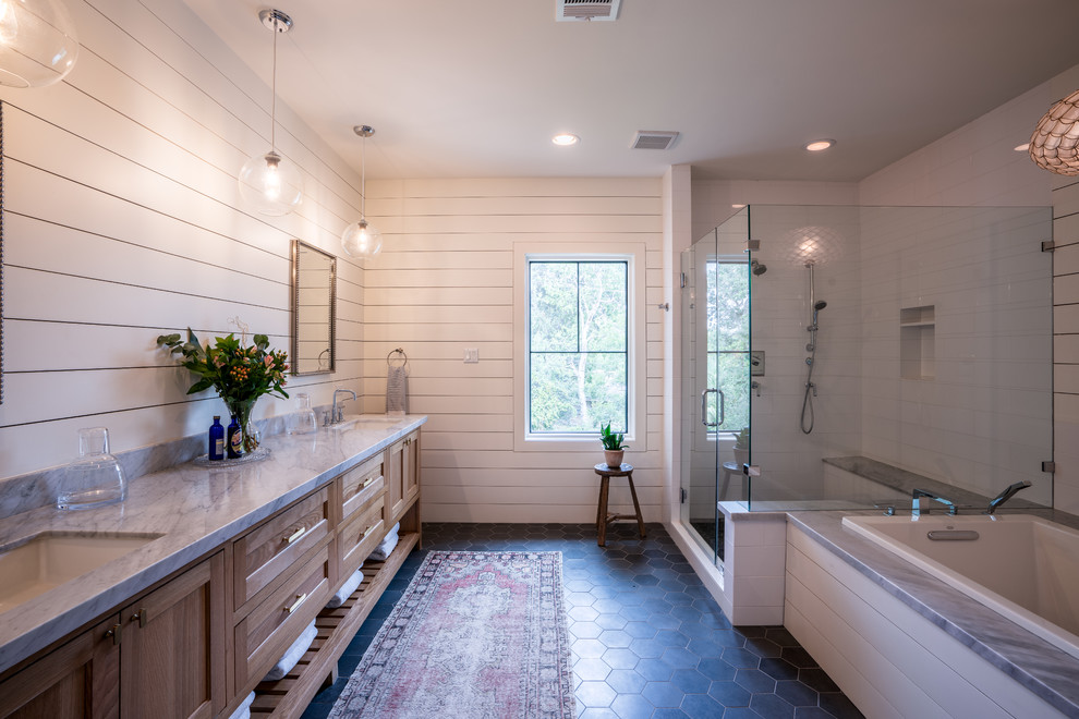 Inspiration for a country bathroom in Other with shaker cabinets, marble benchtops, a hinged shower door, medium wood cabinets, a drop-in tub, a corner shower, white walls, an undermount sink, blue floor and grey benchtops.