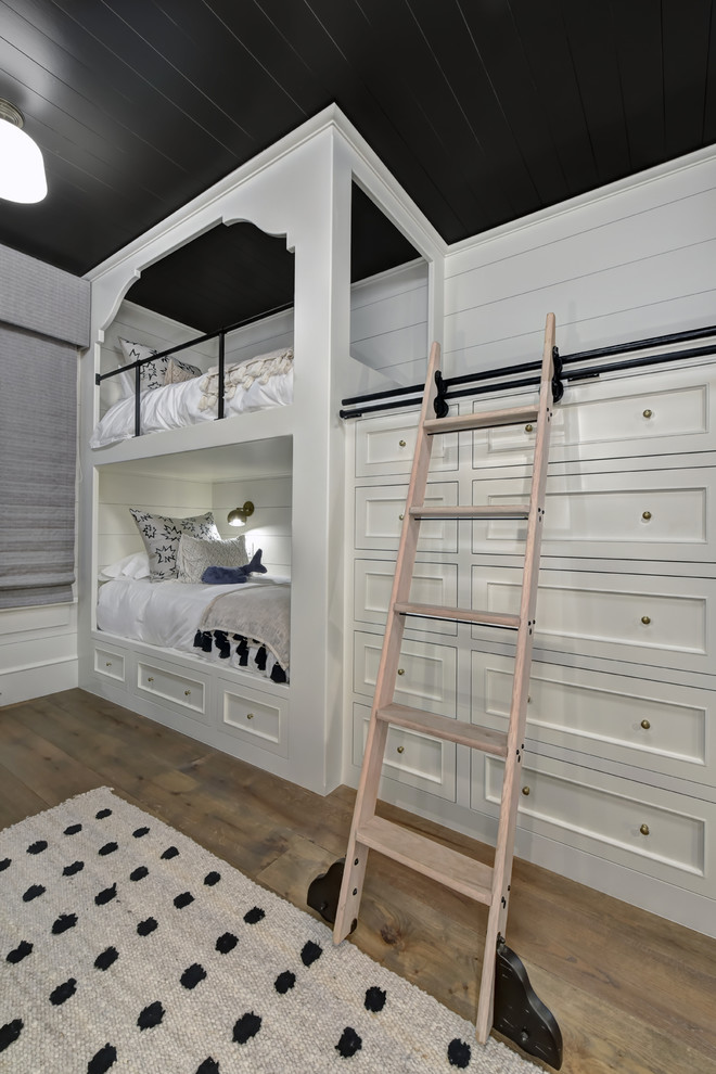 Photo of a mid-sized country gender-neutral kids' bedroom for kids 4-10 years old in Charleston with medium hardwood floors and brown floor.