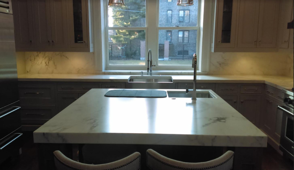 Inspiration for a transitional kitchen remodel in Chicago with shaker cabinets, white cabinets, marble countertops and an island