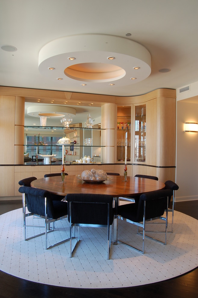Photo of a contemporary dining room in Chicago with dark hardwood floors.