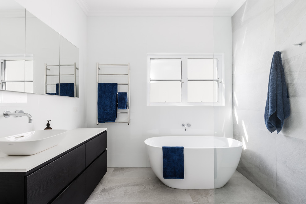 Inspiration for a mid-sized contemporary kids bathroom in London with flat-panel cabinets, brown cabinets, a freestanding tub, an open shower, ceramic floors, quartzite benchtops, grey floor, white benchtops, a single vanity and a floating vanity.