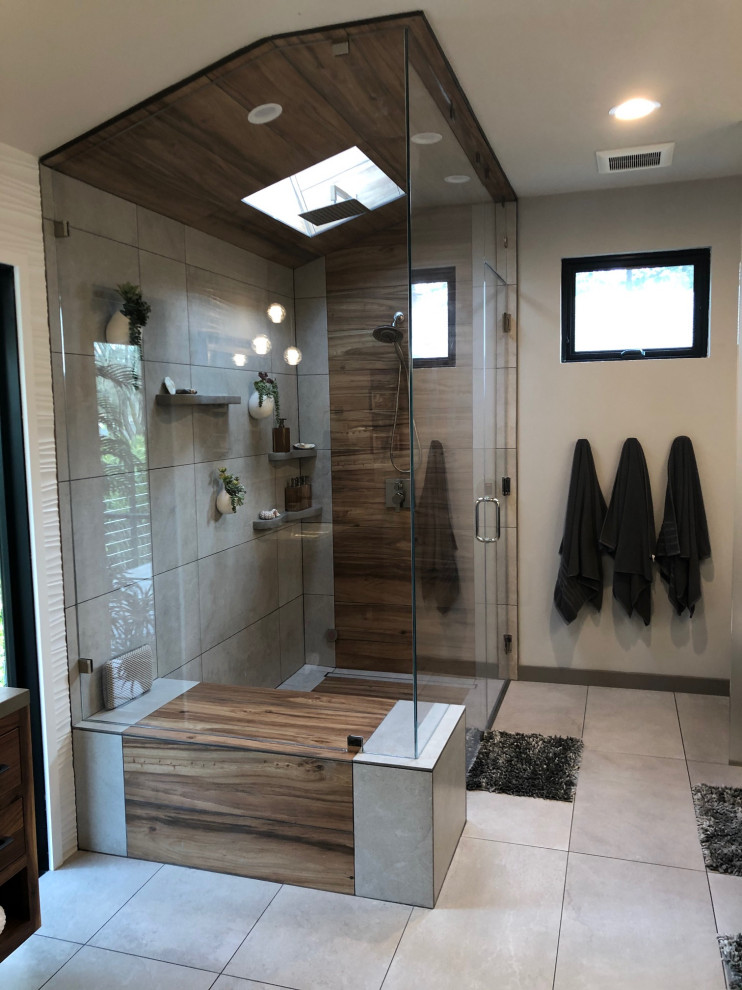 Mid-sized asian master bathroom in San Francisco with recessed-panel cabinets, brown cabinets, a corner shower, a two-piece toilet, beige tile, ceramic tile, beige walls, ceramic floors, a drop-in sink, quartzite benchtops, multi-coloured floor, a hinged shower door, grey benchtops, a shower seat, a single vanity, a floating vanity, vaulted and wallpaper.