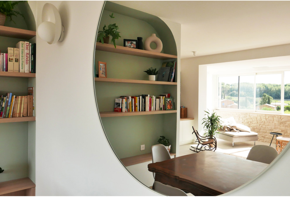 This is an example of an expansive country open concept family room in Marseille with a library, multi-coloured walls, ceramic floors, no tv, grey floor, wood and brick walls.