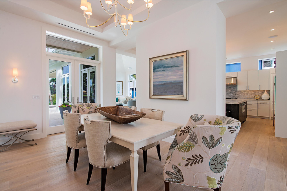 Example of a large transitional medium tone wood floor and brown floor great room design in Miami with white walls and no fireplace