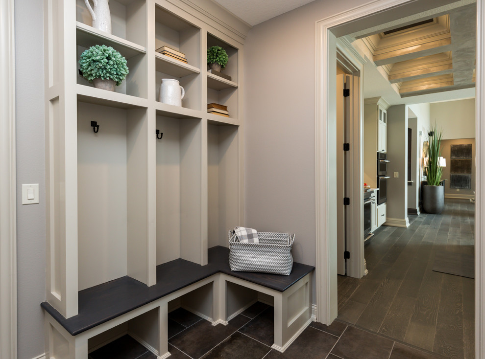 Photo of a small transitional mudroom in Other with grey walls, porcelain floors and brown floor.