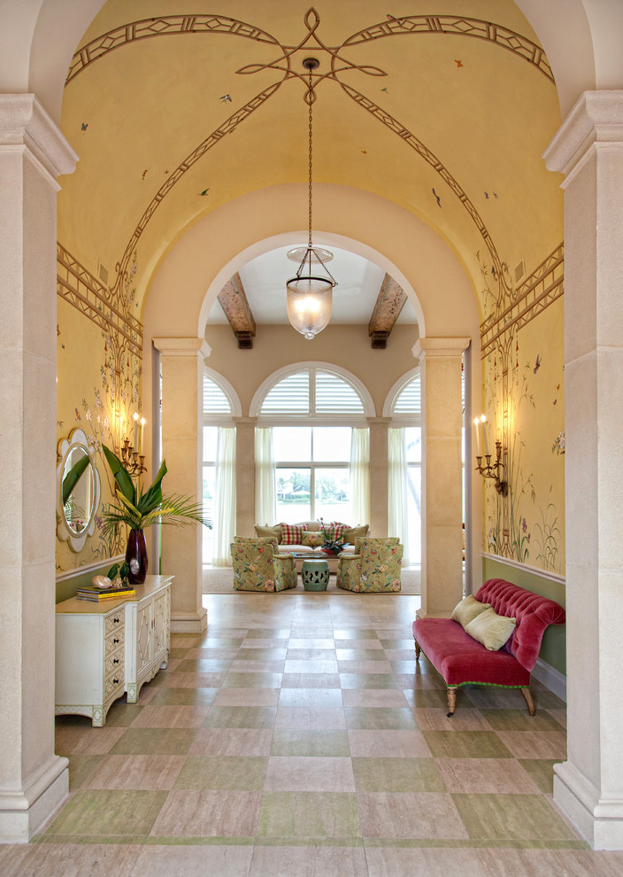 Design ideas for a tropical entry hall in Miami with yellow walls.